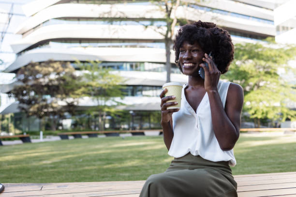 istock Woman enjoying coffee while having a phone call outdoors 2153447655