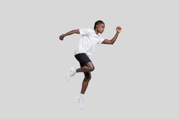 istock Athlete in motion jumping on a gray background 2153447933
