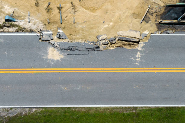 istock Destroyed bridge after hurricane flooding in Florida. Construction roadwork site. Reconstruction of damaged road after flood water washed away asphalt 2153450098