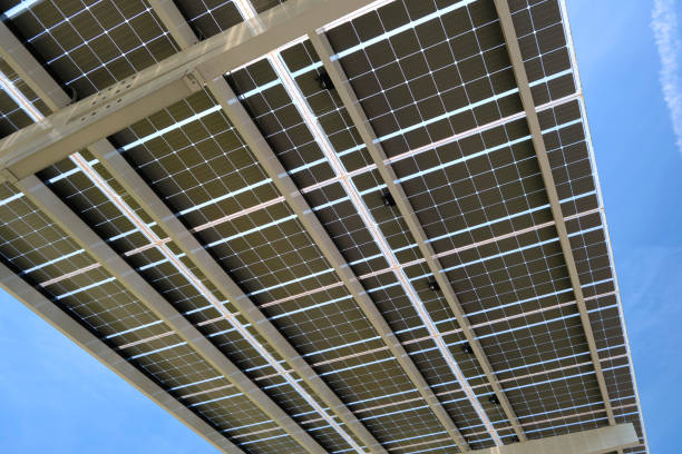 istock Solar panels installed over parking lot canopy shade for parked cars for effective generation of clean energy 2153450118