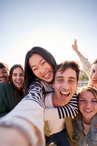istock Group diverse happy young friend taking selfie together looking smiling at camera. Piggyback people. 2153452056