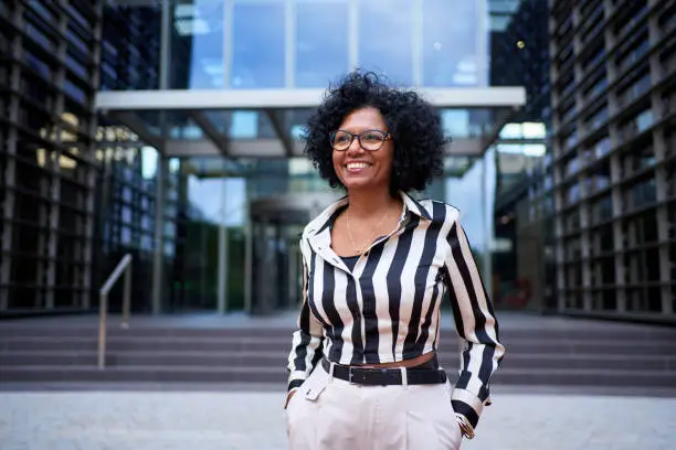 Portrait of African American curly hair business woman cheerful posing for photo standing Portrait of African American curly hair business woman cheerful posing for photo standing