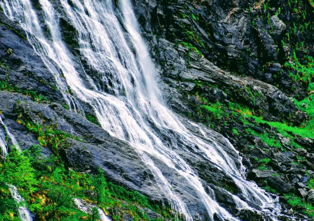 A beautiful waterfall featuring ribbons of water flow over the rock surfaces