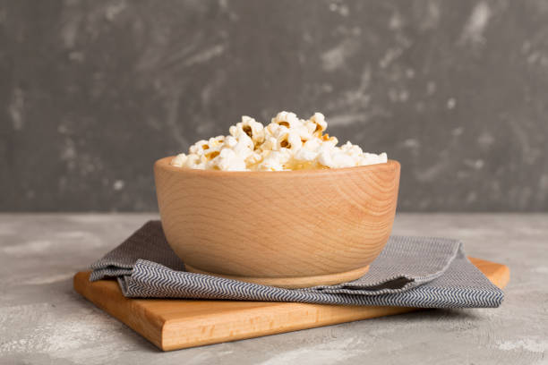 istock Prepared popcorn with ingredients on wooden table 2153453924