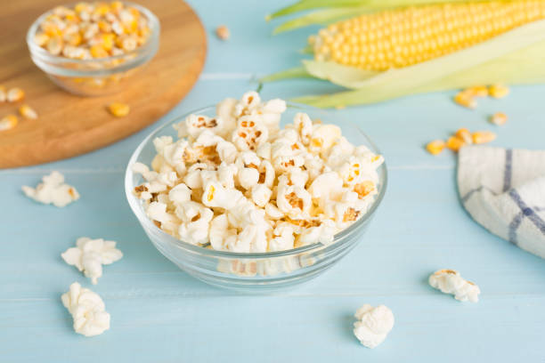 istock Prepared popcorn with ingredients on wooden table 2153453966