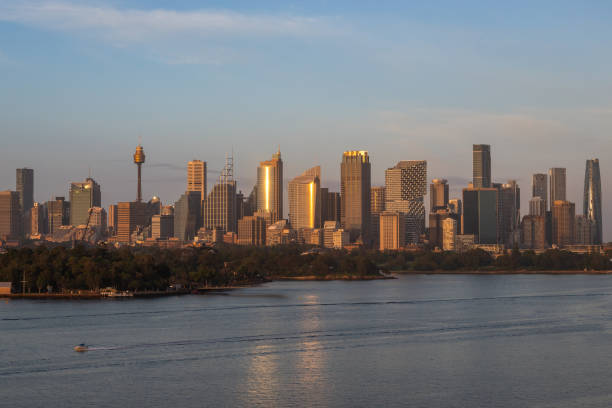 Extraordinary view of Sydney's Icons, namely the Sydney Opera House, Sydney Harbor Bridge and Sydney Downtown, while arriving by cruise ship in a beautiful sunrise.