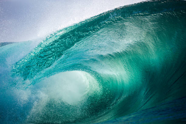 istock Beautiful jade colored ocean wave breaking over a shallow reef 2153457832