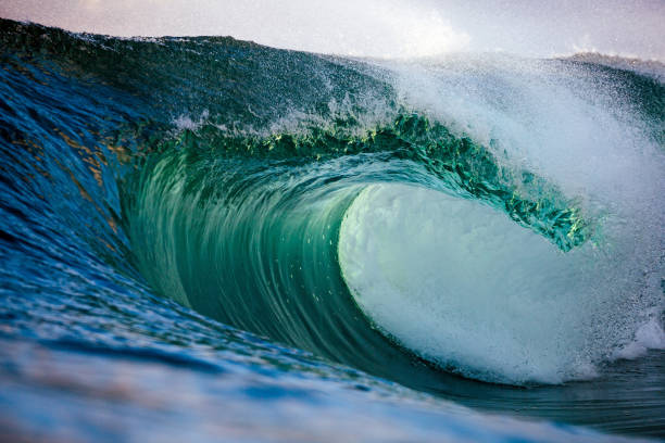 istock Beautiful jade colored ocean wave breaking over a shallow reef 2153457837