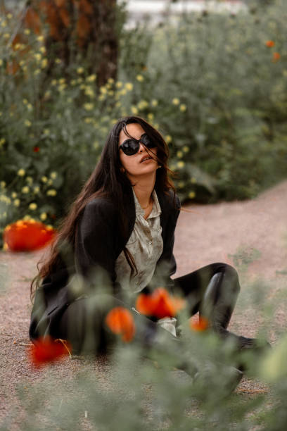 istock attractive woman posing sitting on the road 2153466367