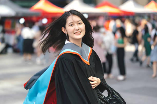 Thai asian University students graduation day costume pose for a portrait.