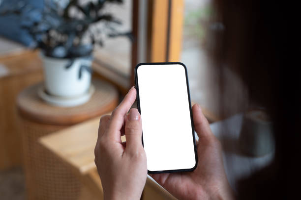 istock Mockup, woman's hand holding using mobile phone at coffee shop with copy space, white blank screen for text, mobile app design and advertsing, online marketing 2153475169