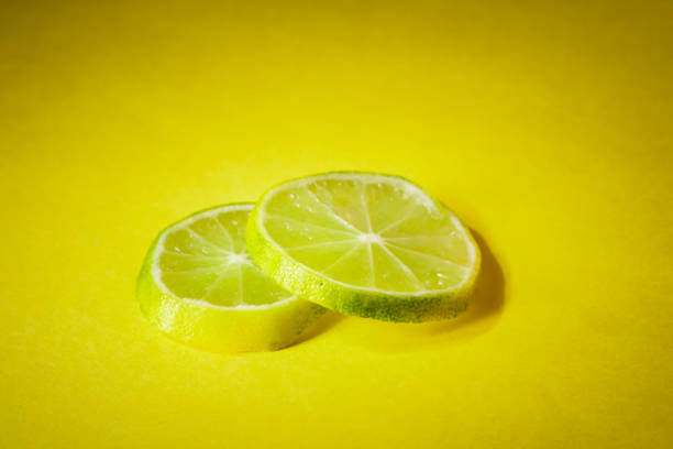lemon slices against yellow background.