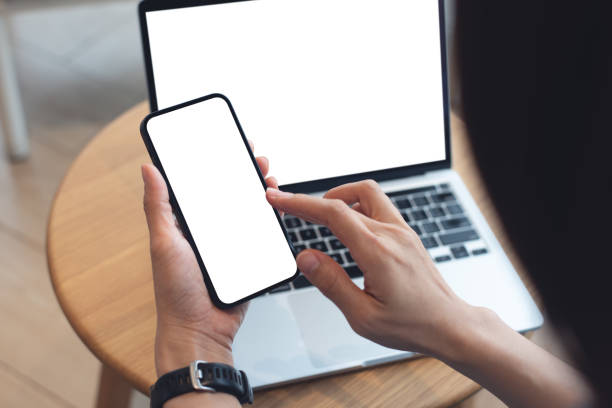 istock Mockup blank white screen mobile phone. Woman sitting at table in cafe, using empty screen smartphone. template for display your product advertisement, mobile app design 2153478615