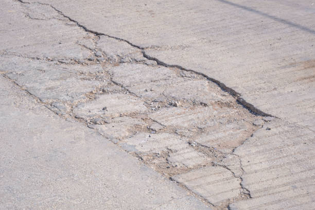 istock Cracks and broken texture with collapse of the old badly damaged concrete street surface 2153478875