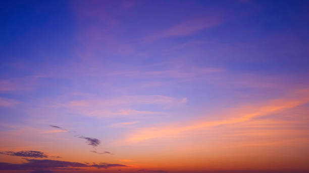 istock Sunset sky background with colorful orange and pink clouds on idyllic blue evening twilight sky, beautiful romantic sunrise sky backdrop 2153479199