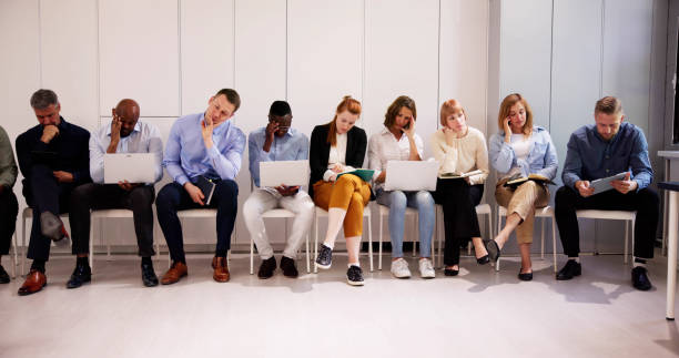 istock Unemployed Job Seekers. Bored People Waiting 2153481900