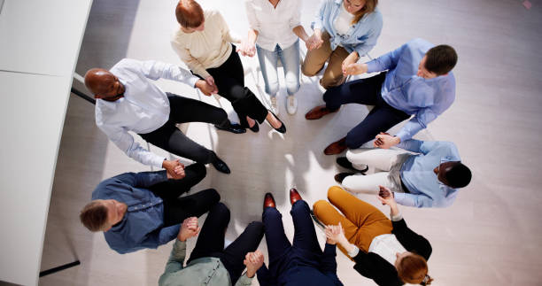 istock Group Of People Sitting Together Praying 2153481987