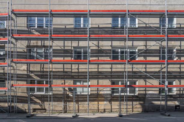 Old Residential Building Renovation Site With Scaffolding Lit By Sunlight