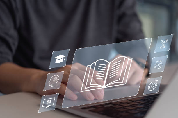 istock A man interacts with a digital book and educational icons on a futuristic interface. 2153486438