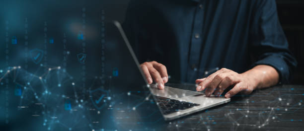 istock Focused professional working on cybersecurity strategies on laptop with digital security icons 2153486448