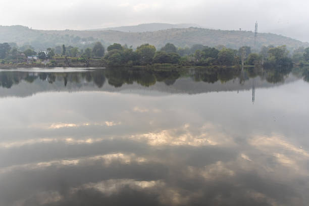 dramatic lake water reflection of cloud with mountain surrounding at morning