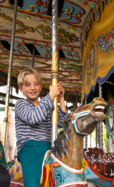 istock Boy enjoying on a merry-go-round at an amusement park 2153487714