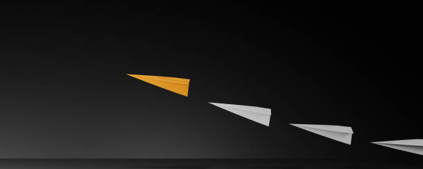 istock Leadership concept with orage paper plane leading among white on dark background. 2153489603