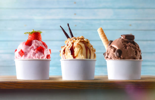 Three glasses of ice cream with balls decorated on table