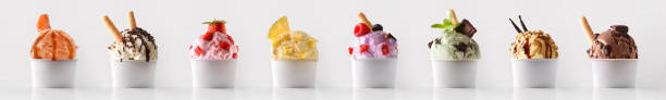 Fruit ice cream with scoop decorated with ingredients in cup