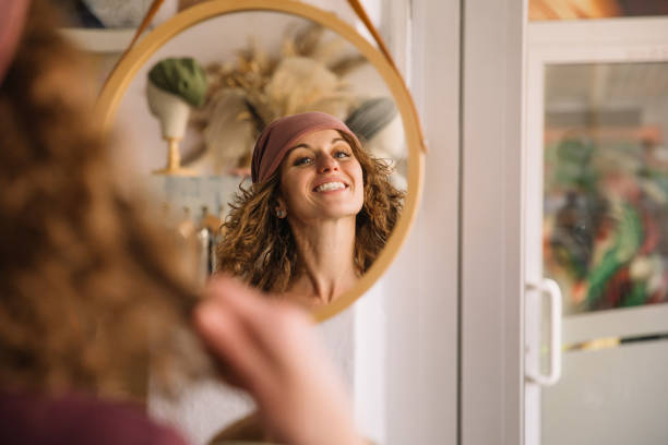 istock Happy Woman Smiling in Reflection of Studio Mirror 2153490591
