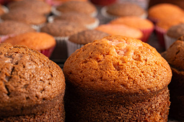 istock Small freshly baked cake and cupcakes in the background. Pastry table. 2153490663