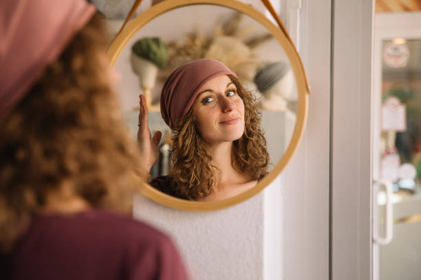 istock Joyful Woman Adjusting Her Headband in Studio Mirror 2153490717