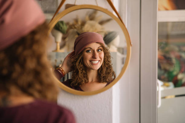 istock Happy Fashion Designer Adjusting Headband While Looking in Mirror in Her Studio 2153490719