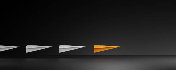 Leadership concept with orage paper plane leading among white on dark background.