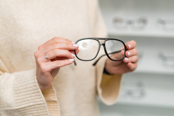 istock Eyewear accessory in woman hands. Modern eyeglasses holding by hands. 2153492107