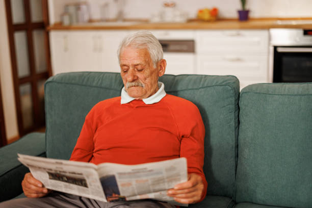 istock Senior man reading newspaper at home 2153493353