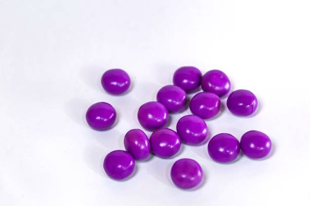istock purple chocolate candy ball isolated on white 2153493638