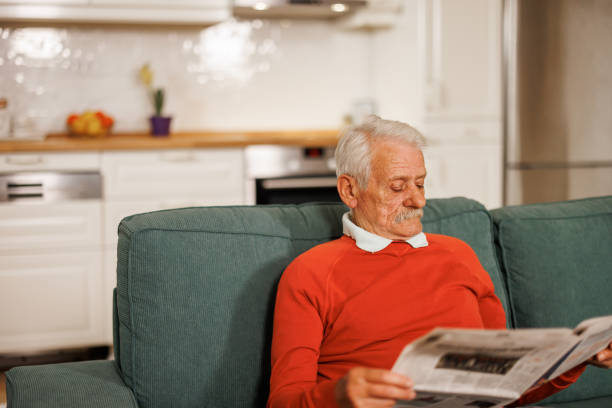 istock Senior man reading newspaper at home 2153493703