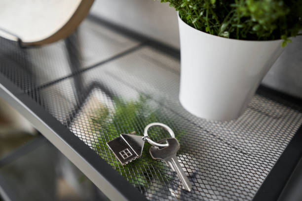 key with house shaped keychain, decor and textiles. concept of buying and selling residential real estate, mortgages, investments. moving to new home.