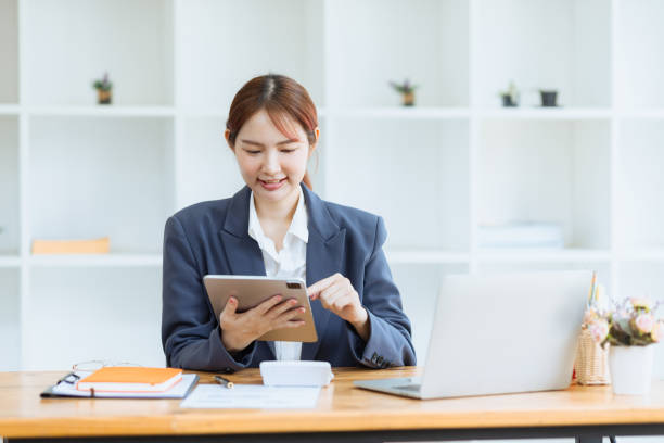 istock Asian business woman using tablet at work inside office. 2153493796