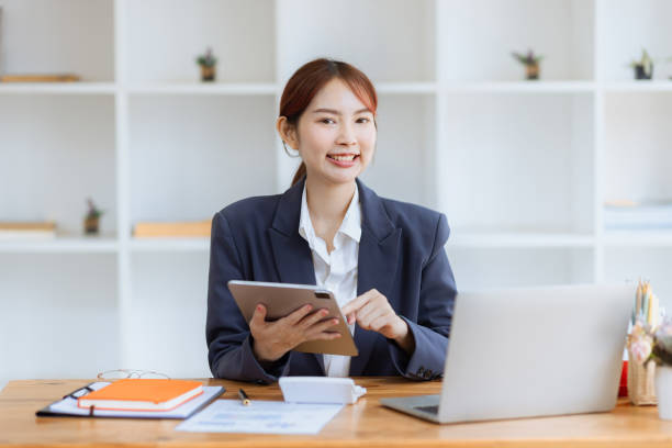 istock Asian business woman using tablet at work inside office. 2153493852