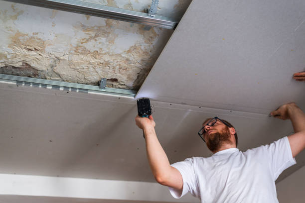 istock Construction worker performs a suspended ceiling maintenance with mineral fiber squares. 2153495971