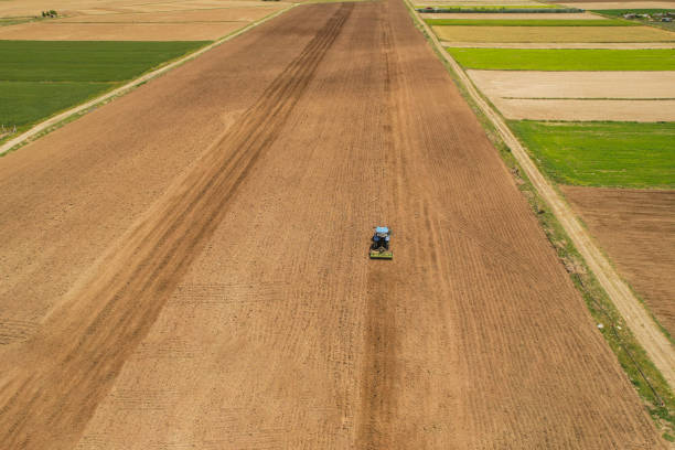 istock Soil cultivation with auto pilot tractor in agricultural land 2153499271