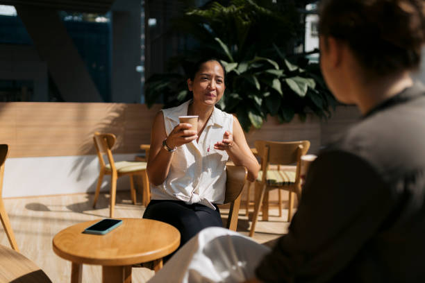istock Two friends engage in meaningful dialogue at coffee shop 2153503845