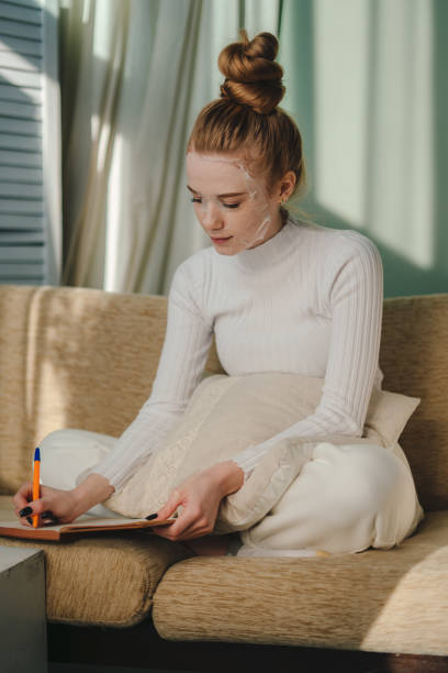 istock Woman leisure on sofa writing notes on diary notebook in lifestyle at home. Relaxation lifestyle concept. 2153503975