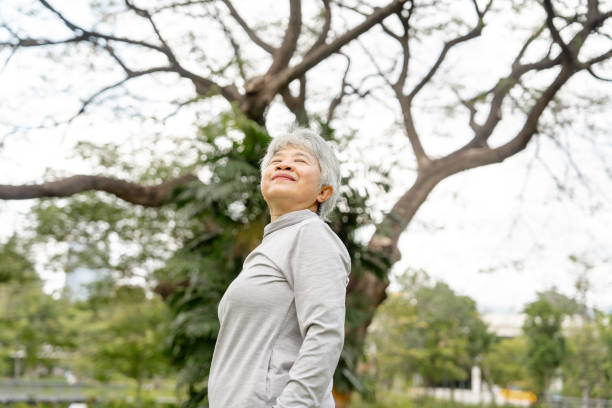 istock Senior Woman's Content Smile in a Sunlit Park 2153508872