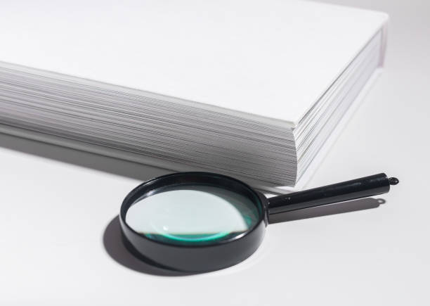 istock Office document magnification, magnifying glass on paper. Business concept with lens and book 2153510679