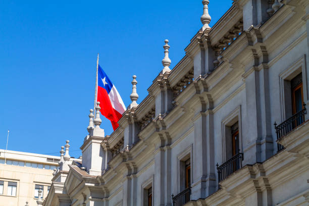 Santiago de Chile, Chile, August 28, 2022: North side of the presidential palace La Moneda on the Plaza de la Constitutión. La Moneda is a neoclassical palace completed in 1805. At the coup d'état of 11 September 1973, the palace was bombed by a military air force and President Salvador Allende shot himself in the encircled building.