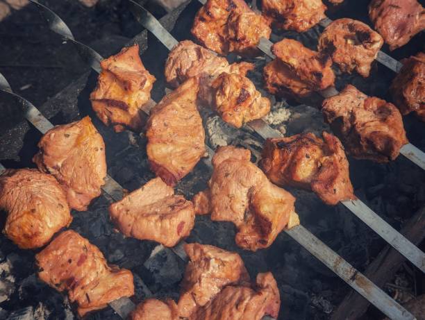 Frying meat, cooking delicious shish kebab, delicious meat dish, hot grill, outdoor recreation.