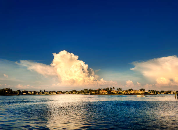 Bright blue ocean with an open sky sun shining through the clouds and reflecting on the ocean in Sarasota, Florida
